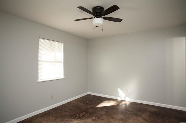 empty room featuring ceiling fan and concrete flooring