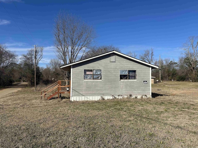 view of side of home featuring a lawn