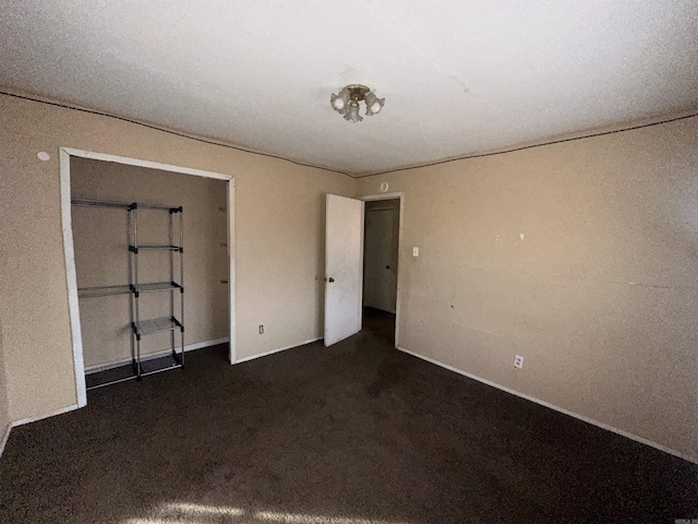 unfurnished bedroom featuring dark colored carpet