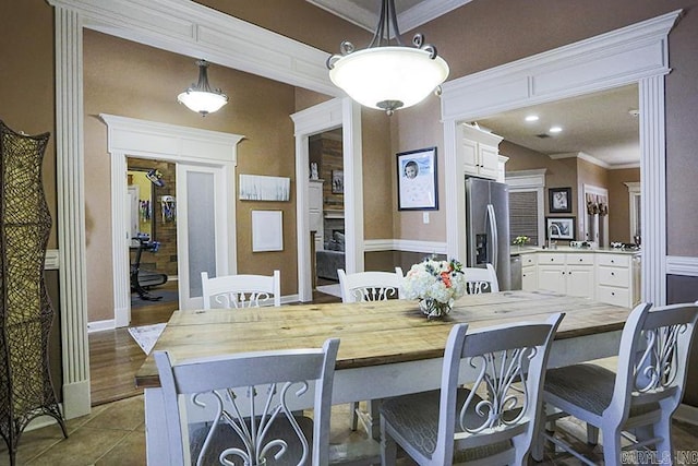 tiled dining room with crown molding