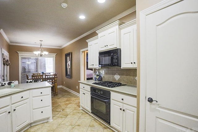 kitchen with sink, white cabinetry, tasteful backsplash, a chandelier, and black appliances