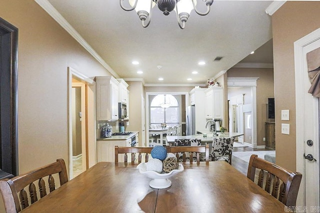 dining room featuring crown molding and a chandelier