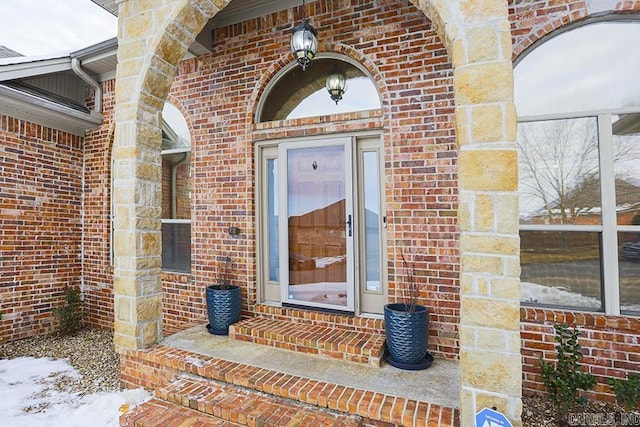 view of snow covered property entrance