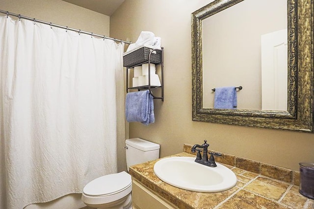 bathroom with toilet and vanity