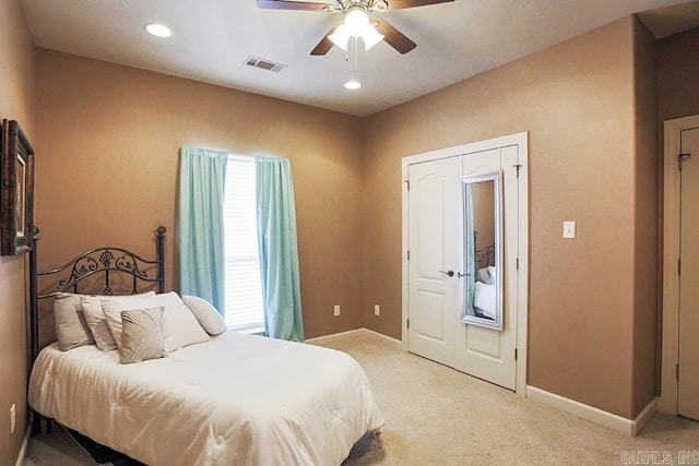 bedroom with light colored carpet and ceiling fan