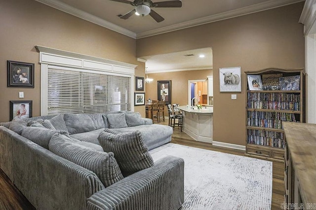 living room featuring ceiling fan, ornamental molding, and hardwood / wood-style flooring