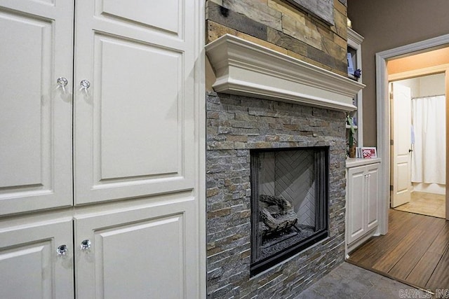 interior details featuring a stone fireplace