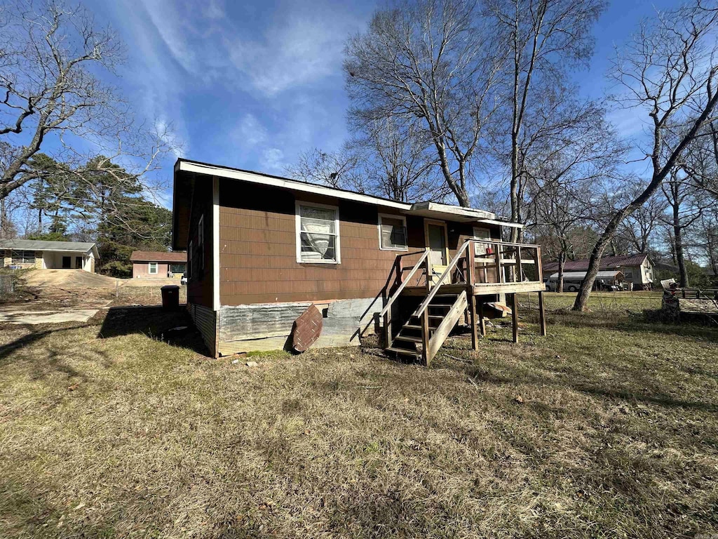 back of house with a yard and a wooden deck