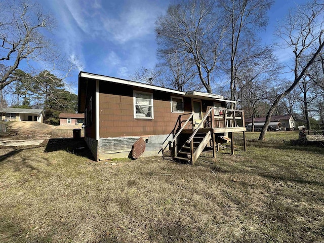 back of house with a yard and a wooden deck