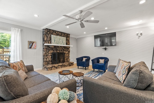 tiled living room featuring wooden walls, a fireplace, ceiling fan, and crown molding