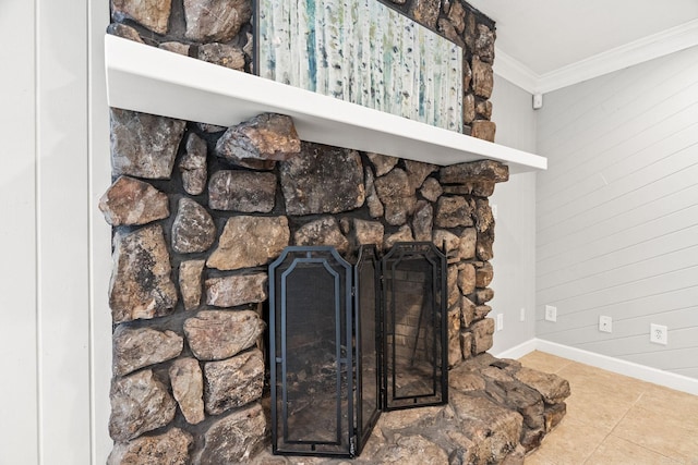 room details featuring ornamental molding and a stone fireplace