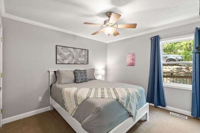 carpeted bedroom with ornamental molding and ceiling fan