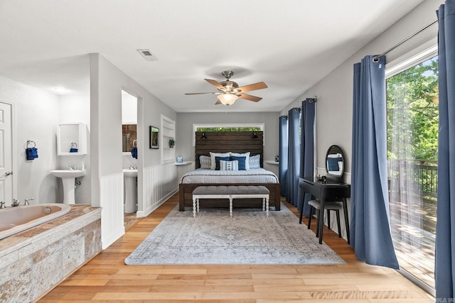 bedroom with light wood-type flooring, ceiling fan, and sink