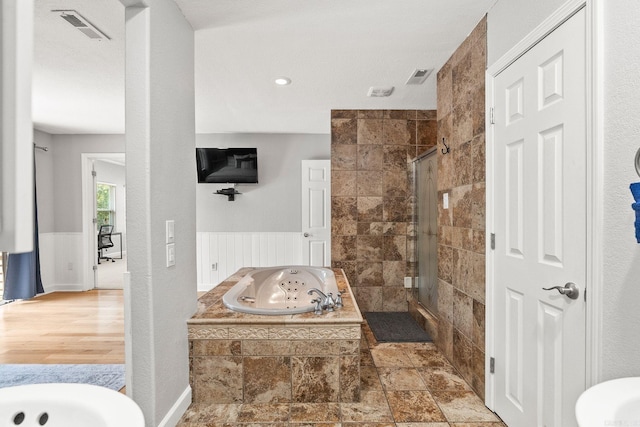 bathroom featuring shower with separate bathtub