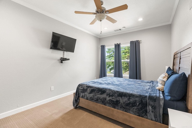 carpeted bedroom with ceiling fan and crown molding