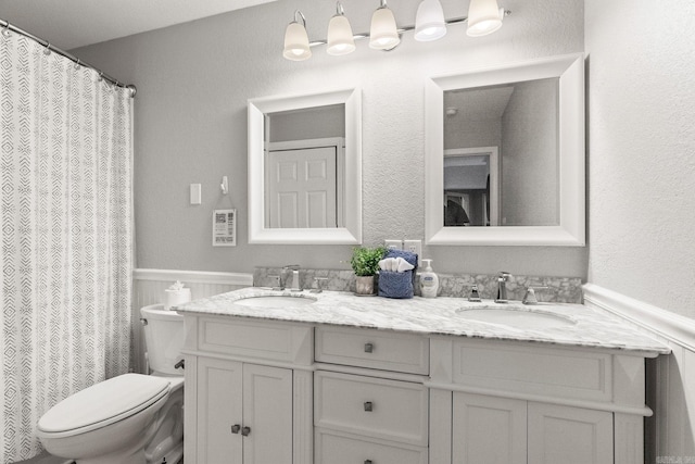 bathroom featuring toilet and vanity