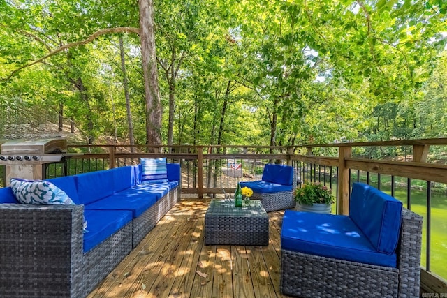 wooden terrace featuring area for grilling and outdoor lounge area