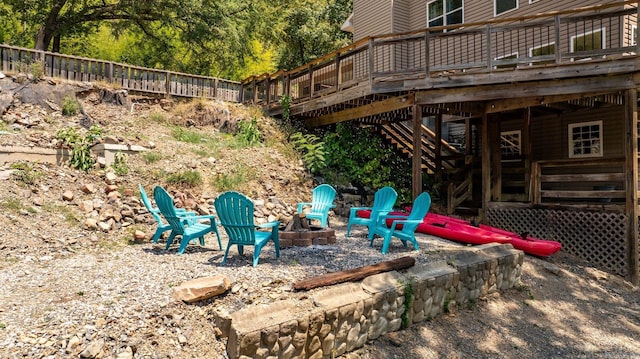 view of yard featuring an outdoor fire pit and a wooden deck