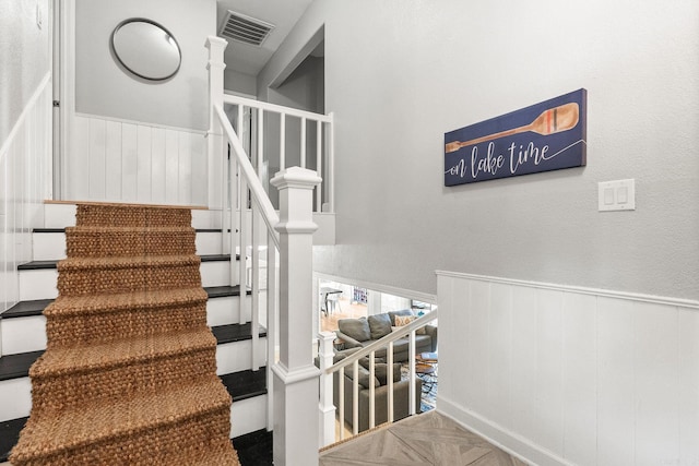 staircase featuring parquet floors