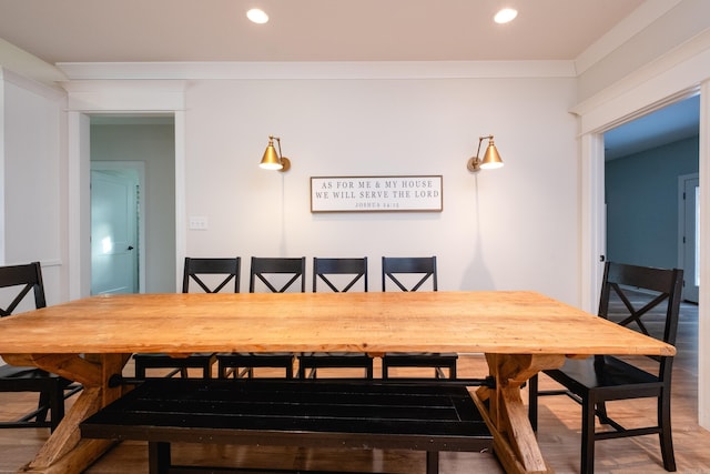 dining room with ornamental molding and hardwood / wood-style floors