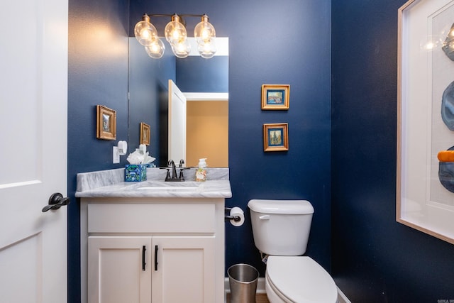 bathroom featuring toilet and vanity