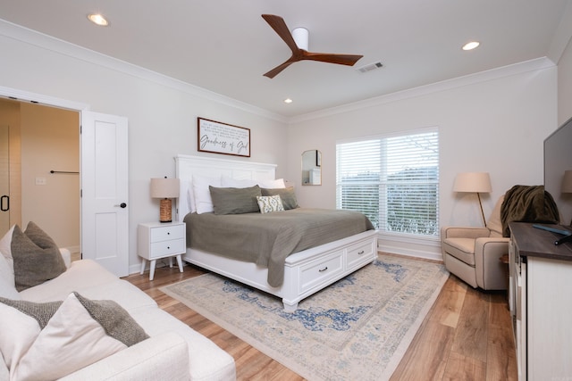 bedroom with ornamental molding, ceiling fan, and light hardwood / wood-style flooring