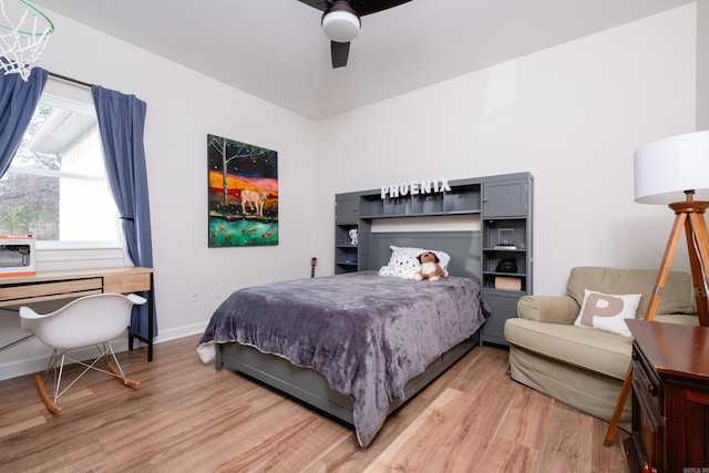 bedroom with ceiling fan and light wood-type flooring