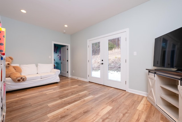 living room with french doors and light hardwood / wood-style flooring