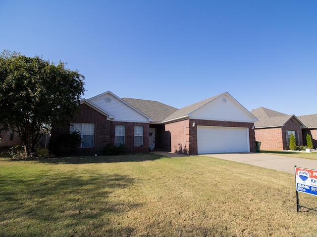 ranch-style home with a garage and a front yard