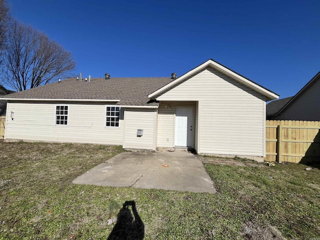 rear view of property featuring a patio and a yard