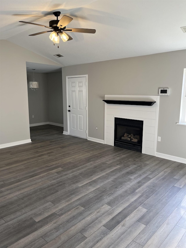 unfurnished living room featuring ceiling fan, vaulted ceiling, and dark wood-type flooring