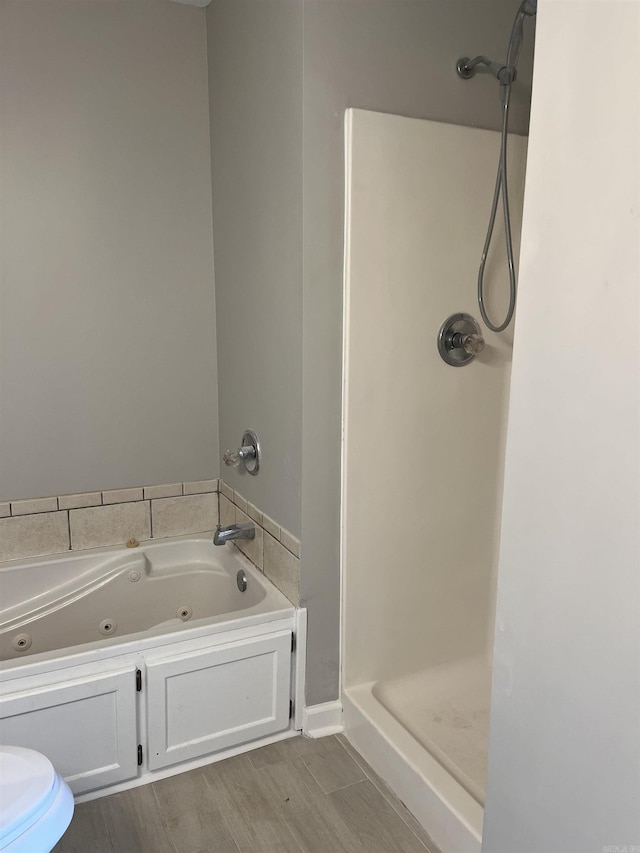 bathroom featuring wood-type flooring and independent shower and bath