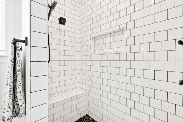 bathroom with a tile shower