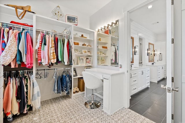 spacious closet with sink and tile patterned floors