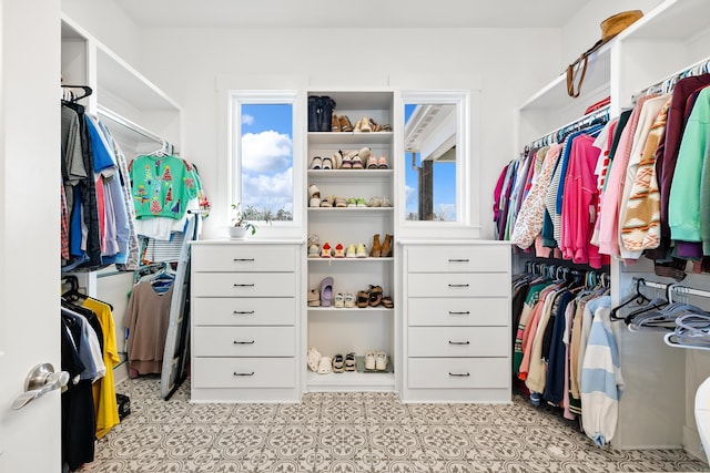 walk in closet with light tile patterned flooring