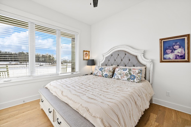 bedroom with ceiling fan and light hardwood / wood-style floors