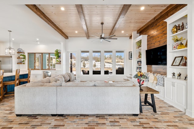 living room featuring ceiling fan, wooden ceiling, and beamed ceiling