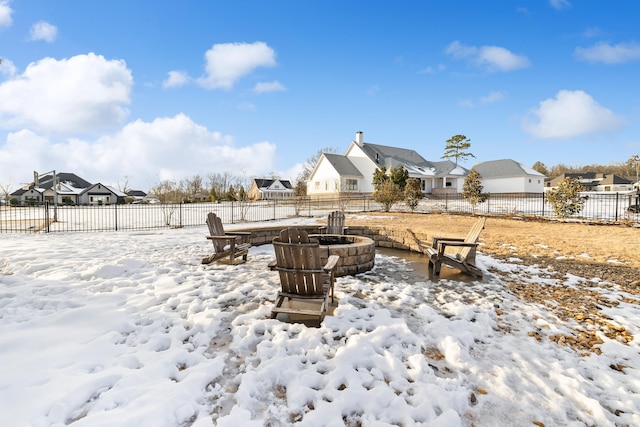 yard covered in snow with a fire pit