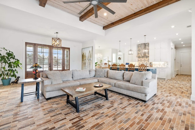 living room featuring beam ceiling, french doors, wooden ceiling, and ceiling fan with notable chandelier