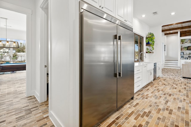 kitchen featuring pool table, pendant lighting, white cabinets, appliances with stainless steel finishes, and sink