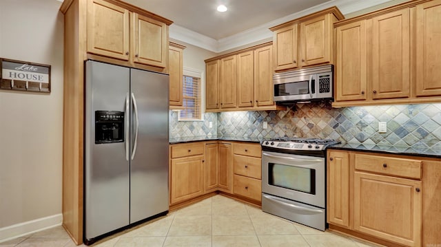 kitchen with backsplash, appliances with stainless steel finishes, ornamental molding, and light tile patterned floors