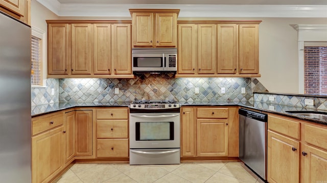 kitchen featuring stainless steel appliances, light tile patterned floors, crown molding, backsplash, and sink