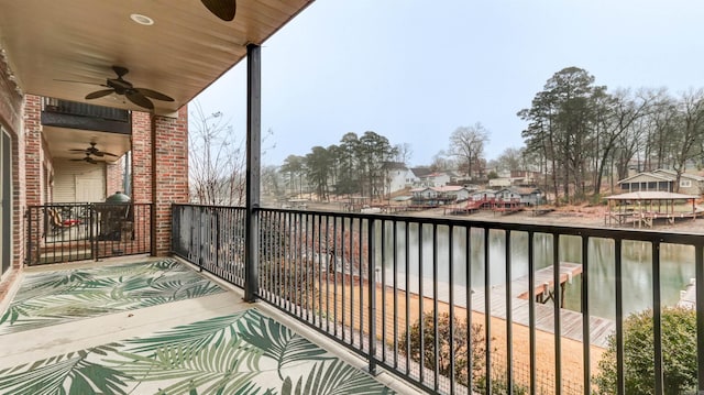 balcony featuring ceiling fan and a water view