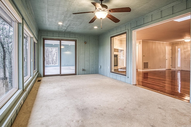 spare room with carpet floors and ceiling fan