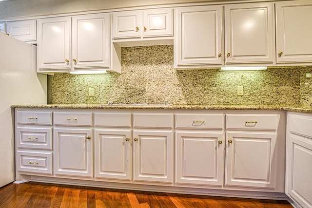 kitchen featuring dark hardwood / wood-style flooring, white cabinetry, and light stone countertops