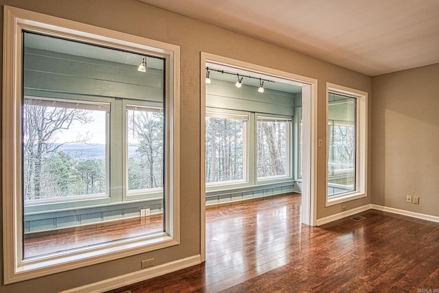 entryway with track lighting and dark hardwood / wood-style floors