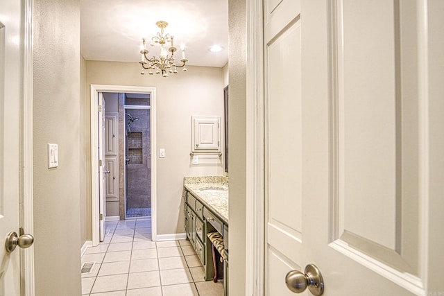 bathroom with vanity, tile patterned flooring, and a chandelier