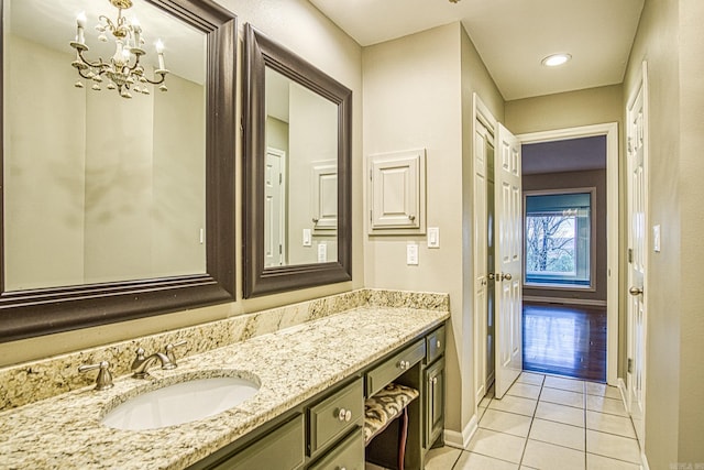 bathroom featuring vanity, tile patterned floors, and an inviting chandelier