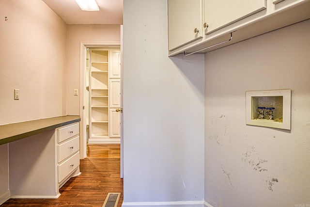 laundry room featuring dark wood-type flooring, cabinets, and hookup for a washing machine