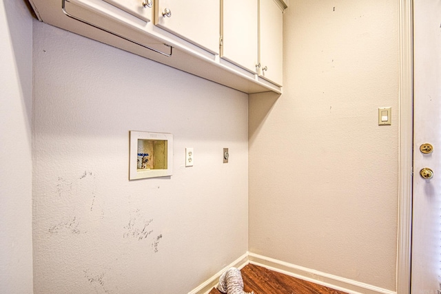 laundry area featuring cabinets, wood-type flooring, and washer hookup